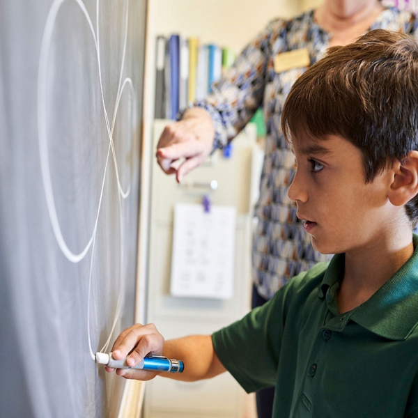 student drawing on the board